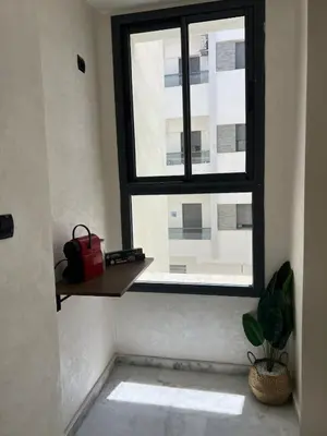 a window in a room with a potted plant at Very nice modern air-conditioned apartment in Fez in Fès
