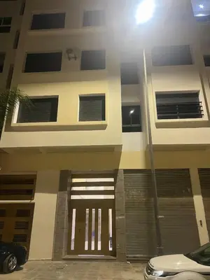 a building with a door and a car parked in front at Very nice modern air-conditioned apartment in Fez in Fès