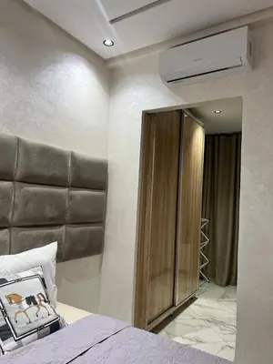 a bedroom with a bed and a mirror at Very nice modern air-conditioned apartment in Fez in Fès