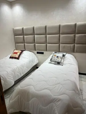 a room with two beds in a room at Very nice modern air-conditioned apartment in Fez in Fès