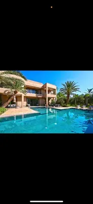 a large swimming pool in front of a house at Villa Marrakech in Oulad Akkou
