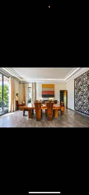 a large living room with wooden tables in it at Villa Marrakech in Oulad Akkou
