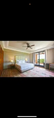 a bedroom with a bed and a ceiling fan at Villa Marrakech in Oulad Akkou
