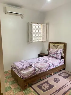 a bedroom with a bed and a window at Dar dyafa in Fès