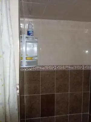 a bathroom with a soap dispenser on a tiled wall at Dar dyafa in Fès