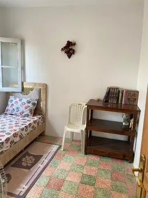 a bedroom with a bed and a desk with a chair at Dar dyafa in Fès