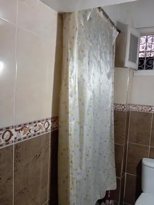 a shower curtain in a bathroom with a toilet at Dar dyafa in Fès