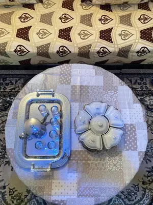 a glass table with a blue case with a flower on it at Dar dyafa in Fès