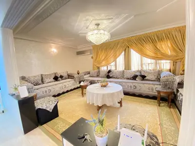 a living room with a couch and a table at Appartement de Luxe Fes Centre Ville in Fès