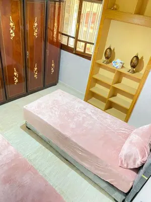 a bed in a room with a shelf at Appartement de Luxe Fes Centre Ville in Fès