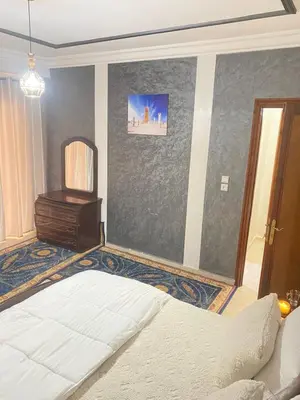 a bedroom with a bed and a television in it at Appartement de Luxe Fes Centre Ville in Fès