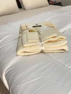a pile of towels sitting on top of a bed at Appartement de Luxe Fes Centre Ville in Fès