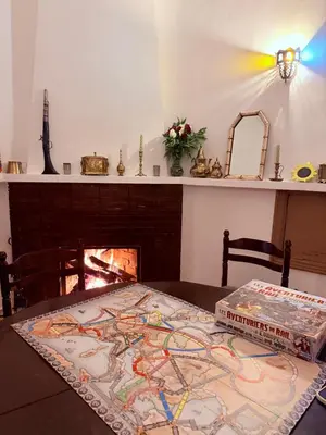a pizza box sitting on top of a table with a fireplace at 3A Retreat Lodge in Ourika
