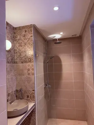 a bathroom with a shower with a toilet and a sink at 3A Retreat Lodge in Ourika