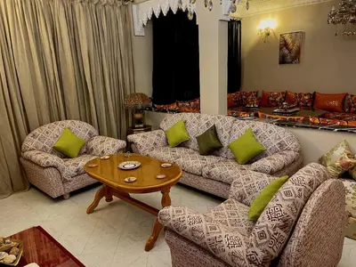 a living room with a couch and chairs and a table at Spacious 140m Family Flat with air conditioner in Fès