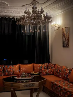 a living room with a couch and a chandelier at Spacious 140m Family Flat with air conditioner in Fès