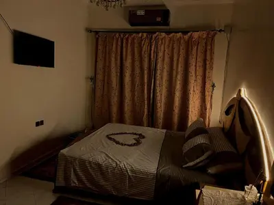 a small bedroom with a bed and a window at Spacious 140m Family Flat with air conditioner in Fès