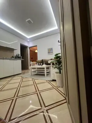 a kitchen and a living room with a tile floor at Studio lumineux avec terrasse in Er Rachidia
