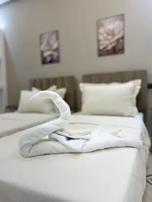two beds with white towels on top of them at Studio lumineux avec terrasse in Er Rachidia