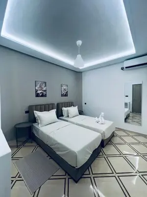 a bedroom with two beds in a room at Studio lumineux avec terrasse in Er Rachidia