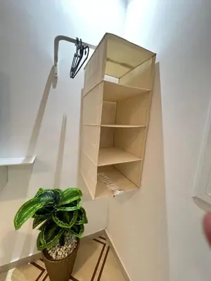 a shelf on a wall with a plant and a lamp at Charment studio avec terrasse in Er Rachidia
