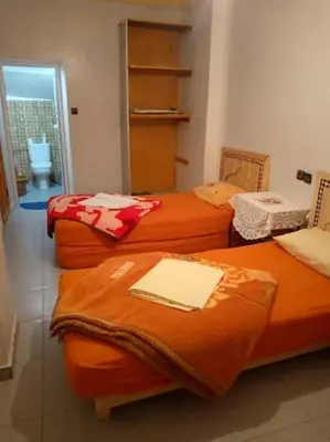 a room with three beds in a room at Ecogite La Tourterelle - Guesthouse in Kalaat MGouna