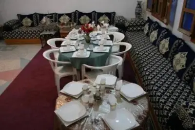 a dining room with a long table and chairs at Ecogite La Tourterelle - Guesthouse in Kalaat MGouna