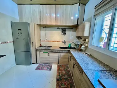 a kitchen with a refrigerator and a counter top at Luxury Apartment Fes - Premium Area in Fès