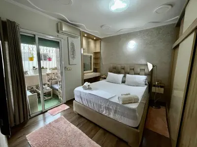 a bedroom with a large bed and a large window at Luxury Apartment Fes - Premium Area in Fès