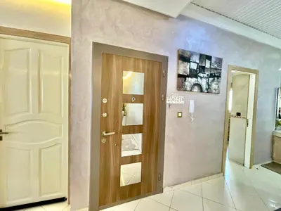 a hallway with a wooden door and a wall at Luxury Apartment Fes - Premium Area in Fès