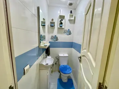a small bathroom with a toilet and a sink at Luxury Apartment Fes - Premium Area in Fès