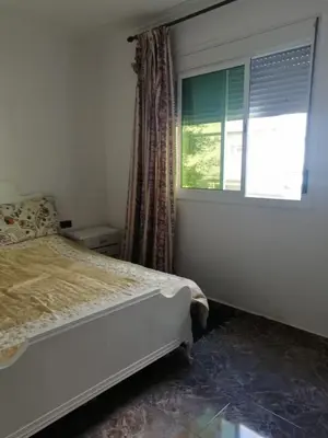 a bedroom with a bed and a window at Entire home in Tangier, Morocco in Oulad Akkou