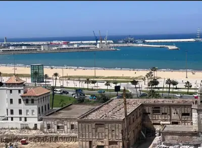 a view of a beach and buildings and the ocean at Entire home in Tangier, Morocco in Oulad Akkou