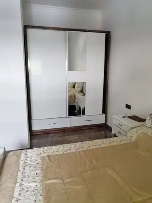 a bedroom with a mirror and a bed and a dresser at Entire home in Tangier, Morocco in Oulad Akkou
