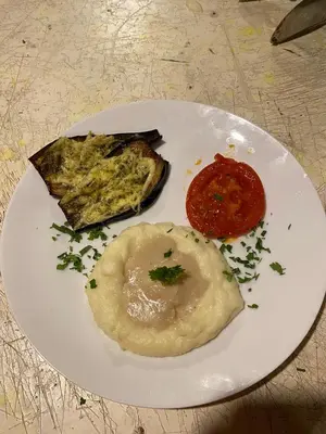 a plate of food with eggs and tomato sauce at DesertGlow camp in Merzouga