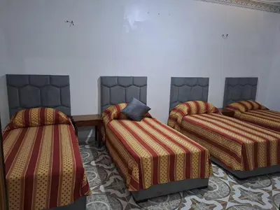 a room with three beds in a room at اقامااات رضى in Aït Saïd