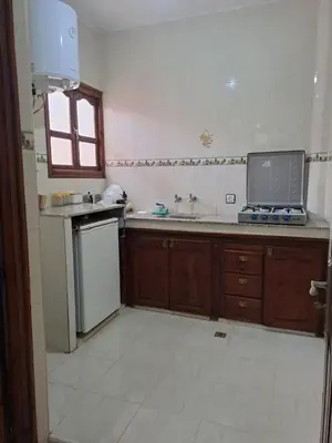a kitchen with a sink and a counter with a laptop at اقامااات رضى in Aït Saïd
