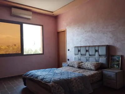 a bedroom with a bed and a window at Dreamy Stay in Ourika NOVA Pool Villa with Atlas Backdrop in Aguelmous