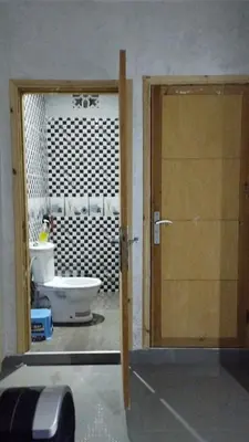 a door to a bathroom with a toilet and a sink at Dreamy Stay in Ourika NOVA Pool Villa with Atlas Backdrop in Aguelmous