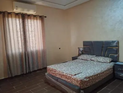a bedroom with a bed and a window with curtains at Dreamy Stay in Ourika NOVA Pool Villa with Atlas Backdrop in Aguelmous