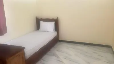 a small bed with a white pillow in a room at Auberge nadia in Sefrou