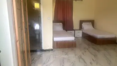 a room with two beds and a mirror at Auberge nadia in Sefrou