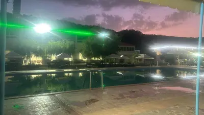 a swimming pool at night with lights at Auberge nadia in Sefrou