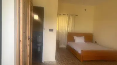a small bedroom with a bed and a toilet at Auberge nadia in Sefrou