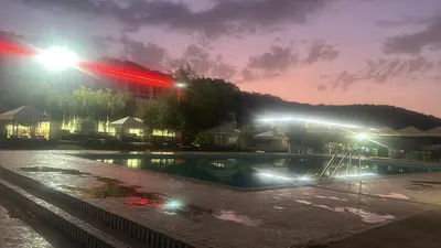 an empty swimming pool at night with lights at Auberge nadia in Sefrou