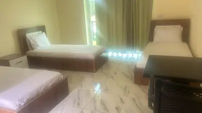 a hotel room with two beds and a window at Auberge nadia in Sefrou