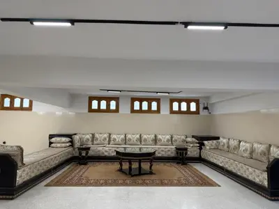 a large living room with couches and a table at Maison De Maitre in Fès