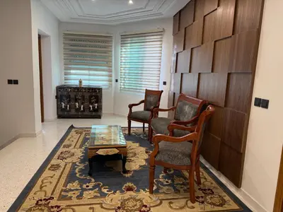 a living room with two chairs and a table at Maison De Maitre in Fès