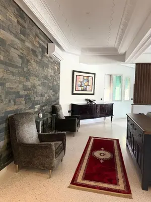 a living room with two chairs and a piano at Maison De Maitre in Fès