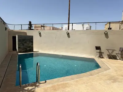 a swimming pool on the roof of a house at Maison De Maitre in Fès
